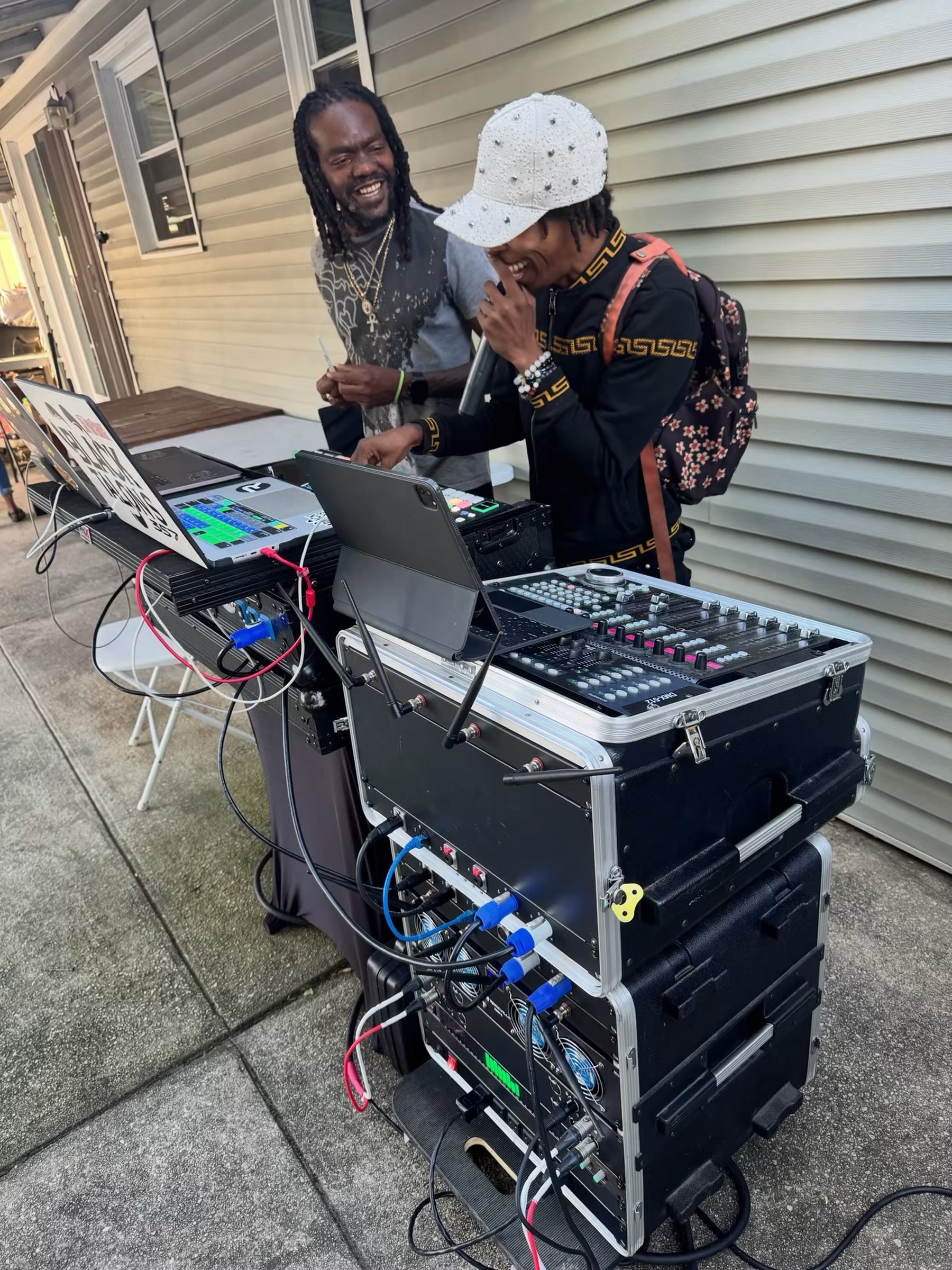 Shorts Temper on the microphone behind the outdoor DJ setup